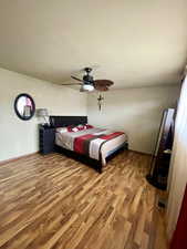 Bedroom featuring light wood finished floors and a ceiling fan