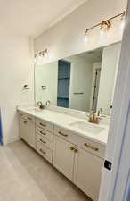Master full bath featuring double vanity and light tile patterned floors