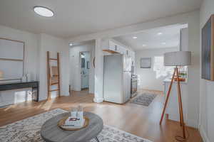 Living room featuring light wood-type flooring and recessed lighting