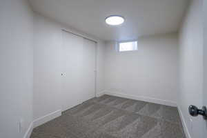 Unfurnished bedroom featuring carpet and a closet