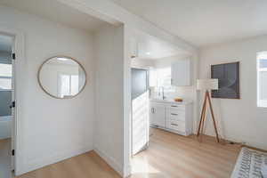 Hall featuring light wood-style floors and baseboards