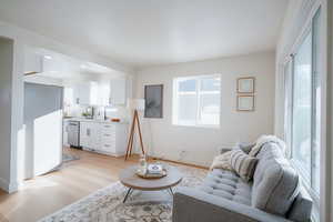 Living room with light wood-style floors and baseboards