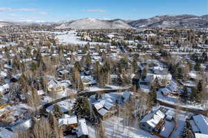 Snowy aerial view featuring a mountain view