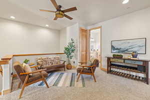 Loft area featuring recessed lighting, light colored carpet, and a ceiling fan