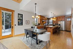Dining area featuring healthy amount of natural light, recessed lighting, a chandelier, and light floors
