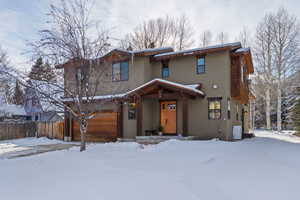 View of front of home with stucco siding and a porch