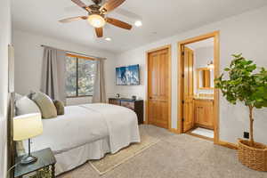 Bedroom featuring light carpet, ceiling fan, connected bathroom, and recessed lighting