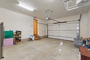 Garage featuring freestanding refrigerator