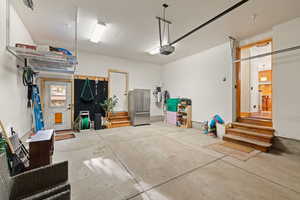 Garage with high quality fridge and a garage door opener