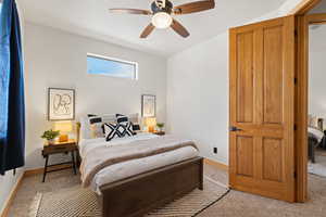 Bedroom with light carpet and ceiling fan