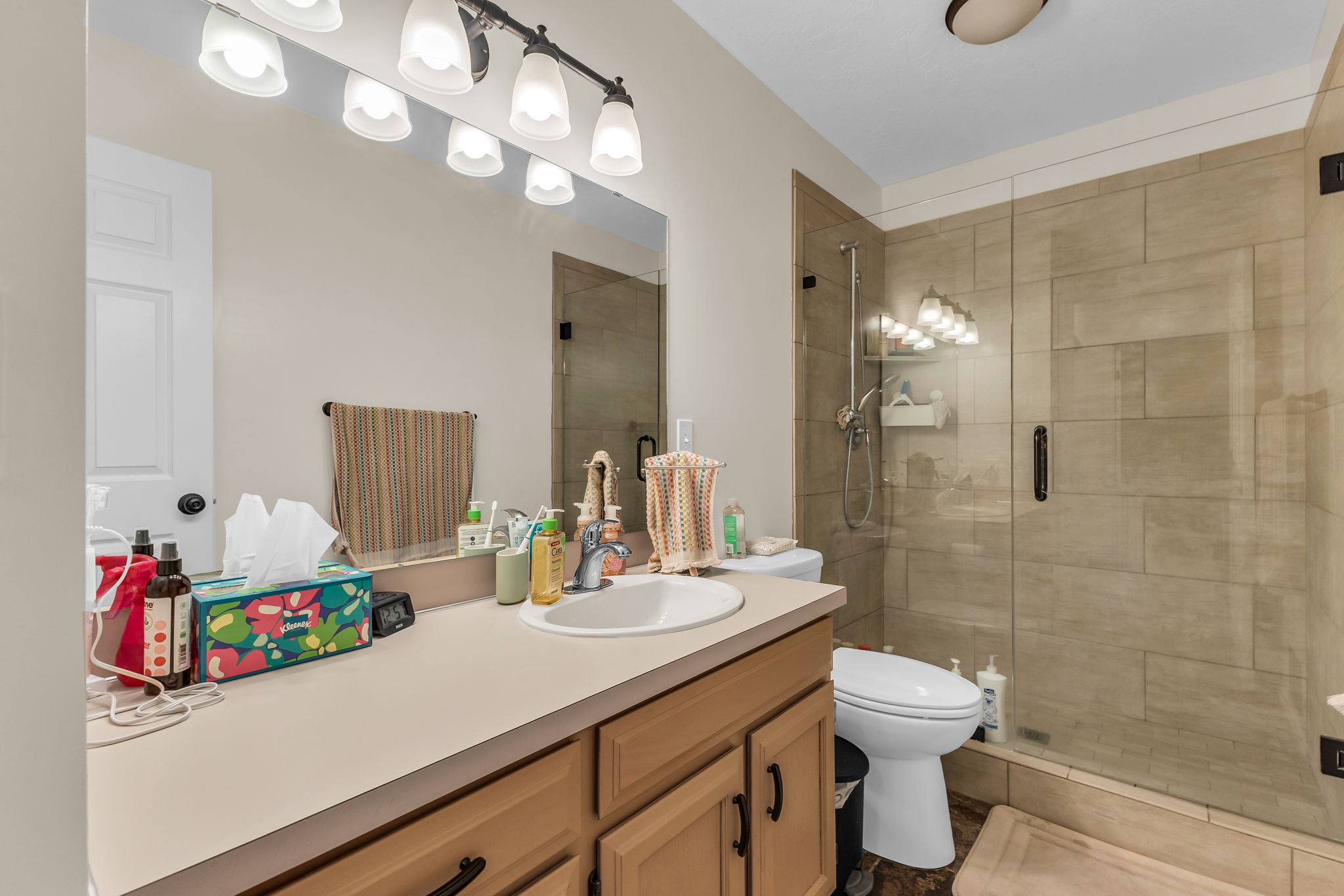 Bathroom with newly finished vanity and tiled walk in shower