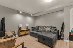 Basement living room with new LVP flooring and new lighting