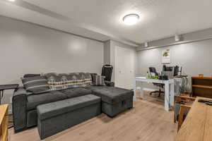 Basement living room with new LVP flooring and new lighting