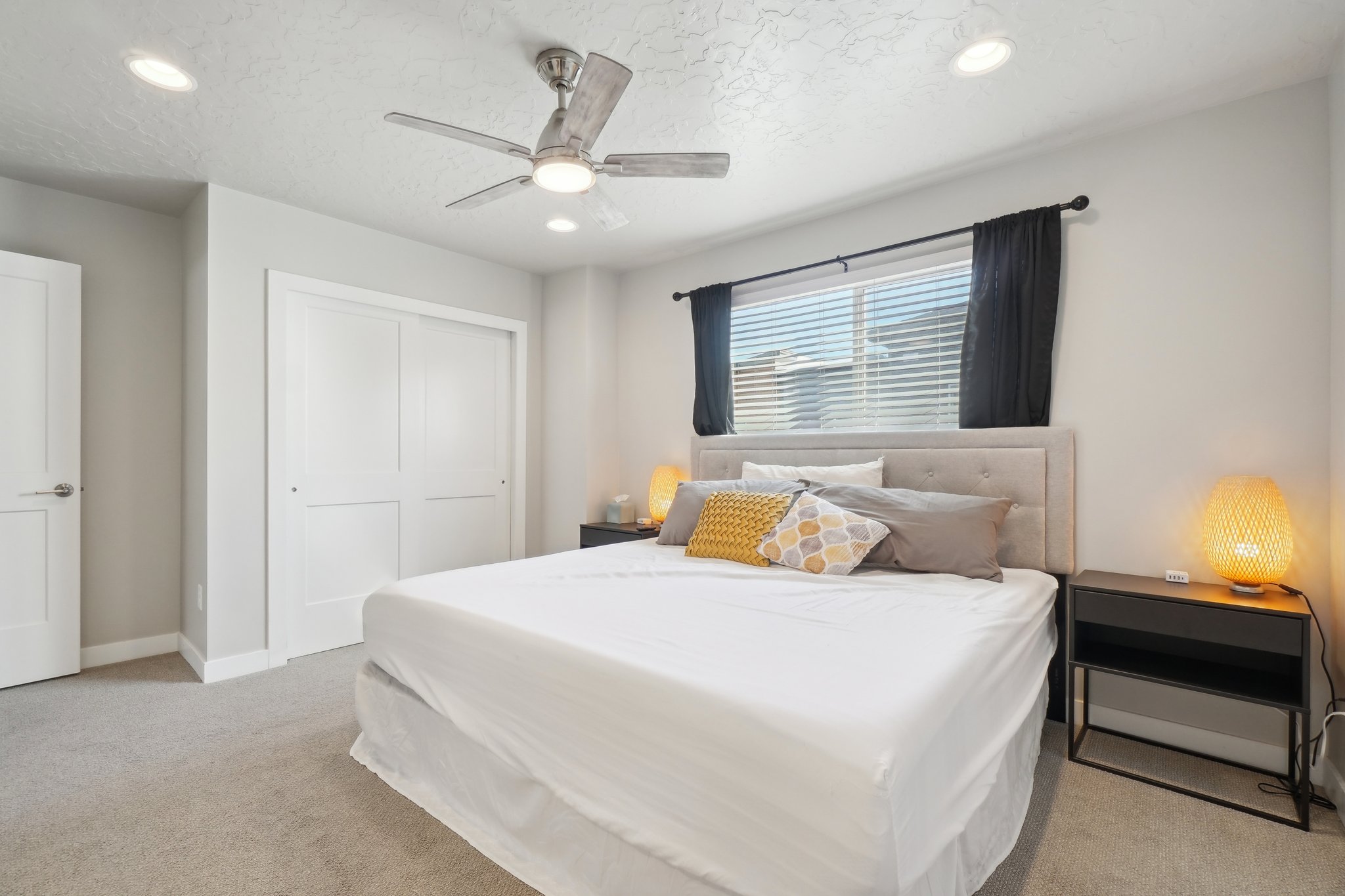 Bedroom featuring a closet, light carpet, a ceiling fan, and recessed lighting
