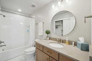 Bathroom featuring shower / tub combo, vanity, light tile patterned floors, recessed lighting, and a walk in closet