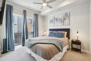 Bedroom featuring access to outside, light carpet, and a ceiling fan