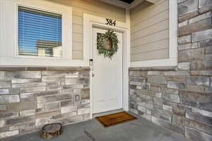Entrance to property featuring stone siding