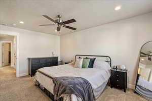 Bedroom featuring recessed lighting, carpet floors, a ceiling fan, and a textured ceiling
