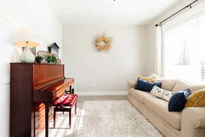 Living room with light colored carpet and baseboards