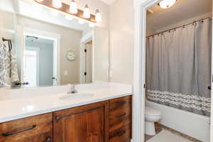 Full bathroom featuring vanity, shower / tub combo with curtain, and wood finished floors