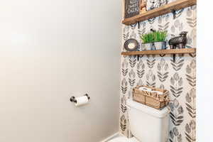 Bathroom with toilet and baseboards