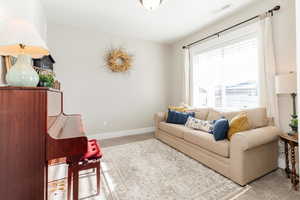 Living room featuring carpet and baseboards