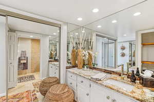 Bathroom with vanity, a walk in shower, recessed lighting, and light tile patterned flooring