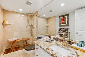 Full bath with a walk in shower, vanity, and recessed lighting
