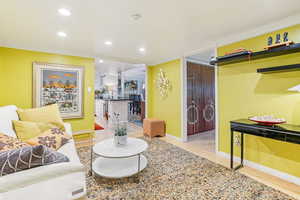 Living area with recessed lighting and light wood-style floors