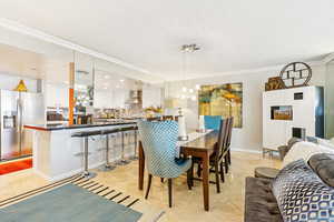 Dining room featuring crown molding and light tile patterned floors