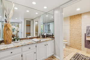 Full bathroom with vanity and recessed lighting