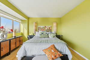 Bedroom featuring light wood-style flooring and baseboards