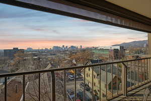 Balcony at dusk with a view of skyline