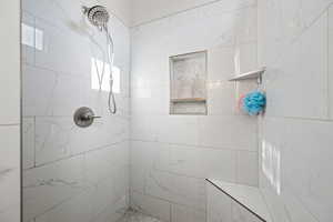 Full bath with a tile shower