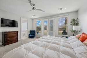 Carpeted bedroom with a ceiling fan, access to outside, and connected bathroom