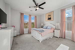 Bedroom with light carpet and a ceiling fan