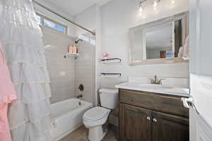 Bathroom with vanity and shower / bath combination with curtain