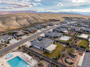 Aerial overview of property's location featuring nearby suburban area and a mountain backdrop