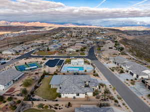 Aerial overview of property's location featuring a mountainous background and nearby suburban area