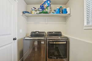Laundry room with washer and clothes dryer