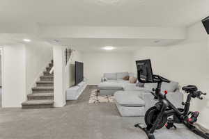 Exercise room with carpet and a textured ceiling