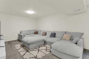 Living room featuring carpet flooring and a textured ceiling