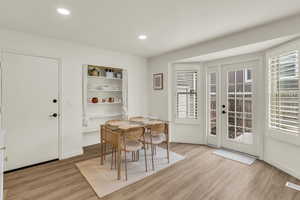 Dining space featuring light wood finished floors and recessed lighting