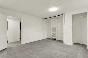 Unfurnished bedroom featuring light colored carpet and a closet