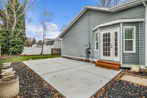 Fenced backyard featuring a patio area, french doors, and entry steps