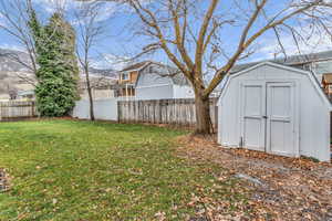 Fenced backyard with a storage unit