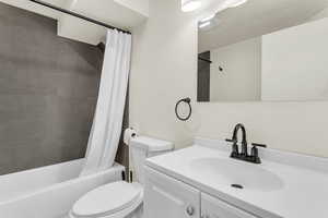 Bathroom with vanity and shower / bath combo with shower curtain