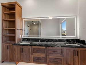 Full bath featuring double vanity and walk in shower