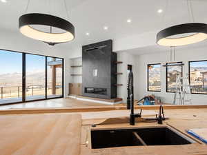 Kitchen featuring a mountain view, a tile fireplace, pendant lighting, recessed lighting, and built in shelves