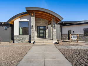 Entrance to property with stone siding and board and batten siding